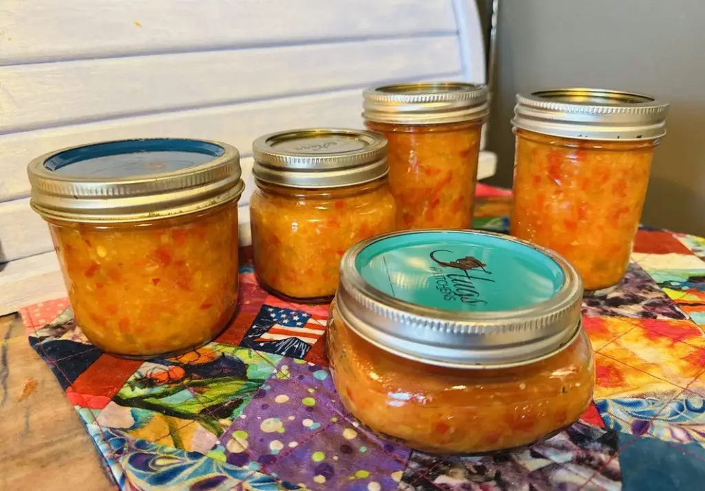 Homemade spicy pineapple pepper sauce in mason jars – sweet and spicy small-batch canning recipe perfect for gifting or charcuterie boards